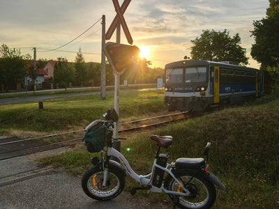 Drvetion CT20 PRO — e-bike parked near a tram at sunset