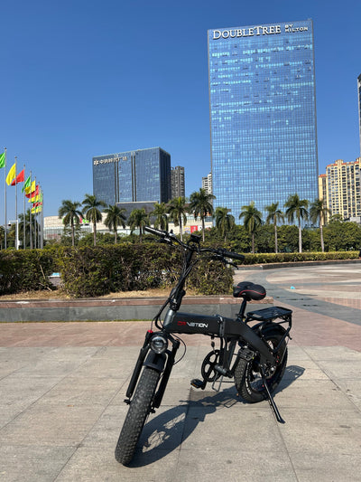 Drvetion BT20 — e-bike front three-quarter view in a plaza