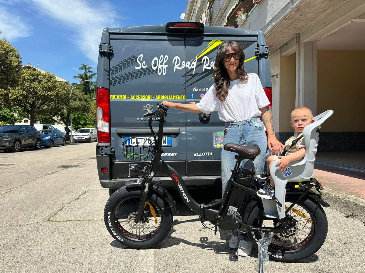 Drvetion CT20 — rider and passenger on an e-bike beside a van